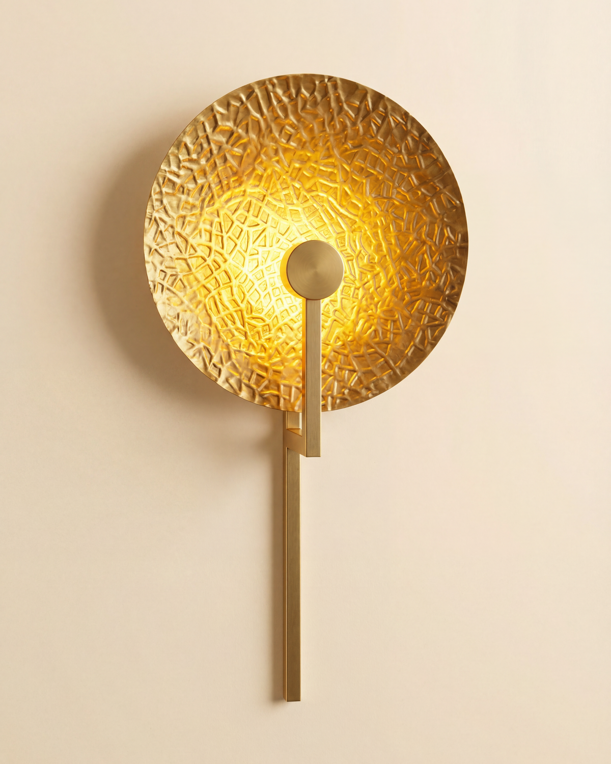 Aaranya Halo Wall Light Handcrafted Solid Brass Designer Wall Sconce | Made in India Gold wall sconce with textured design on a beige wall