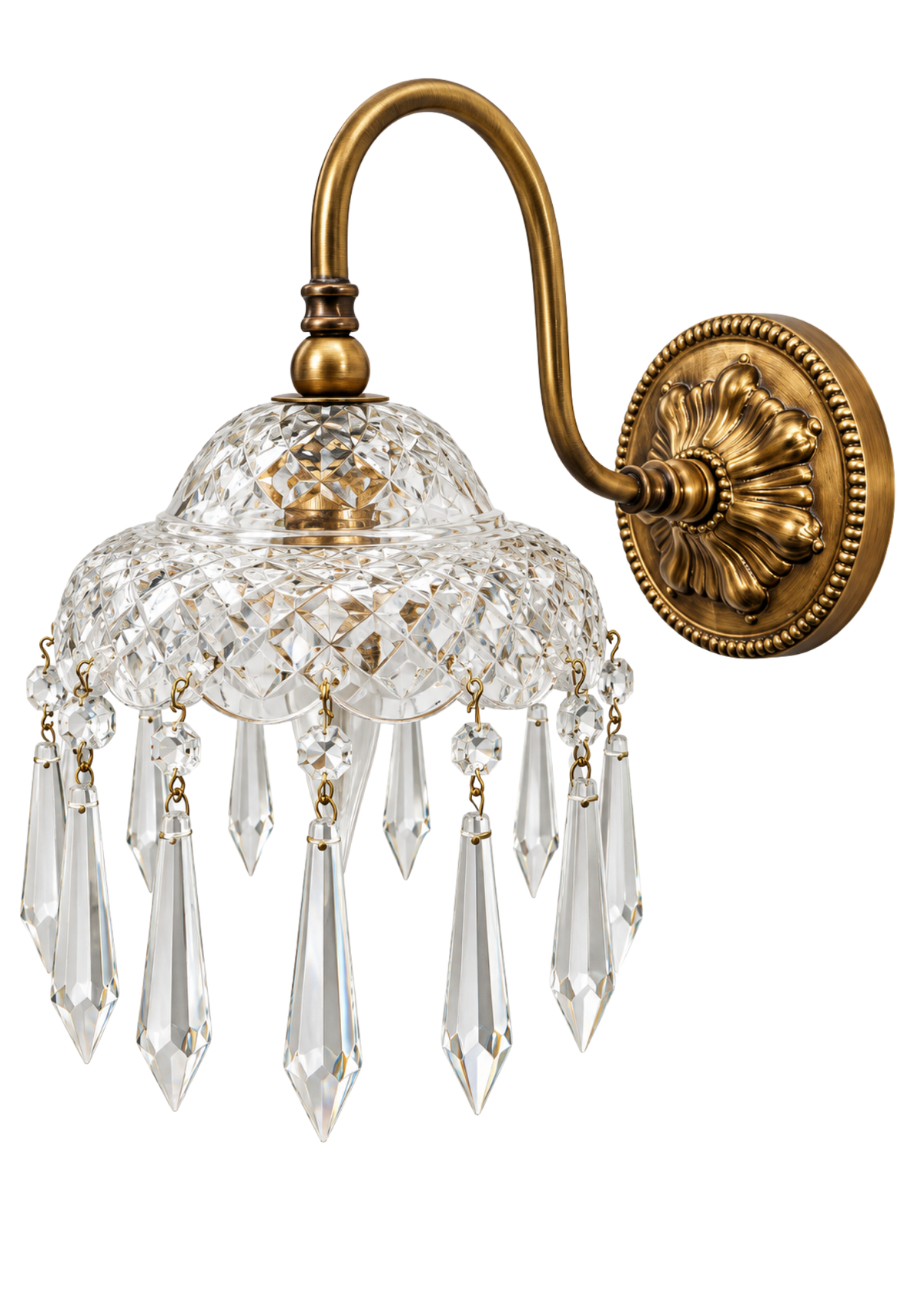 An ornate wall sconce with a polished brass/gold curved arm and round decorative wall plate, featuring a clear cut crystal dome and hanging crystal prisms against a white background.