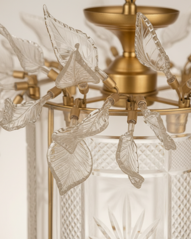 Chandelier with leaf-shaped crystal pendants on a neutral background The Aaranya Noor Heritage Pendant Light is a celebration of refined Indian craftsmanship, designed and handcrafted entirely in-house by Aartaa Decor’s master artisans.