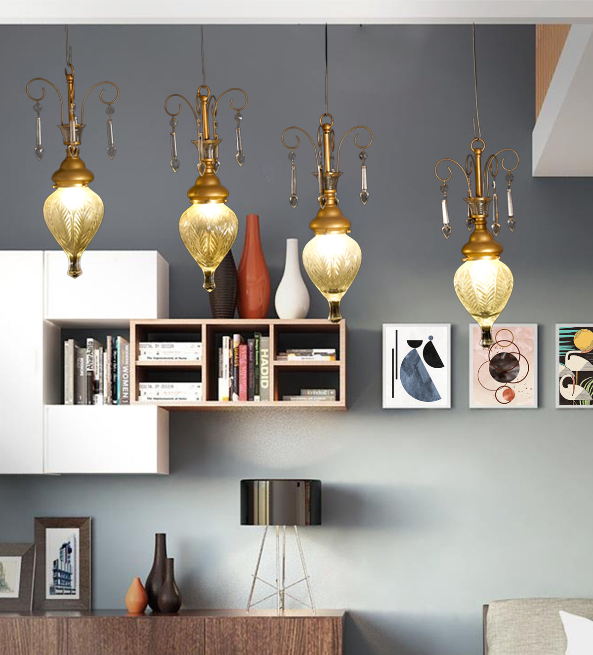 Elegant gold and glass teardrop pendant lights with crystal accents, hanging in a stylish room with yellow walls and a cozy yellow armchair.