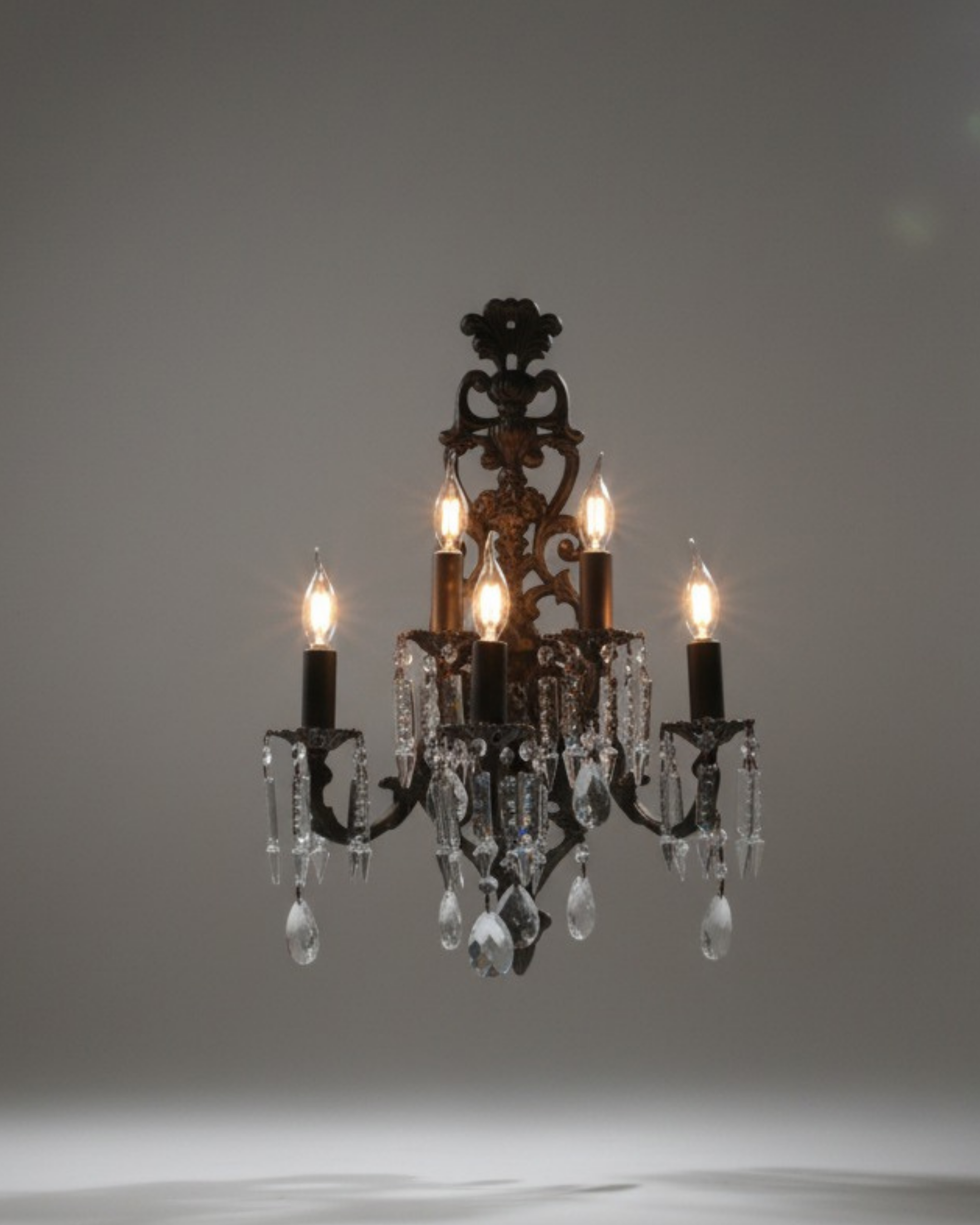 Antique bronze crystal wall light with candle-style bulbs and hanging crystal drops – elegant luxury lighting by Aartaa Decor.