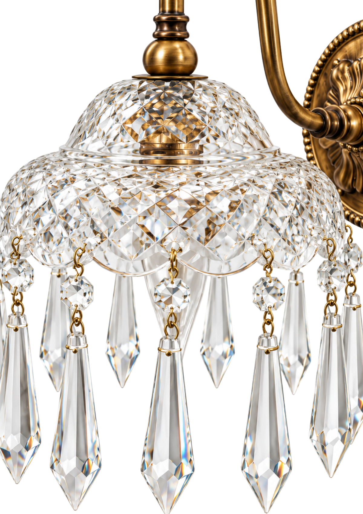 Close-up of a crystal chandelier light fixture with a clear faceted glass shade, hanging crystal prisms, and an antique brass or gold-toned metal mount and arm against a white background.