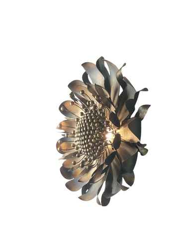 Side view of Golden Bloom Brass Wall Light showing layered brass petals and warm glow