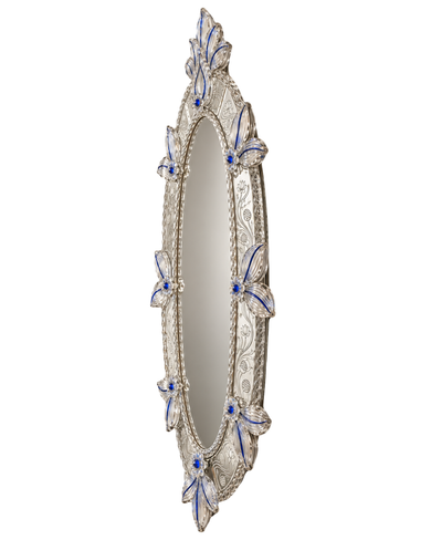 An ornate oval wall mirror with a silver-toned filigree frame and decorative blue and white enamel butterfly accents around the border.
