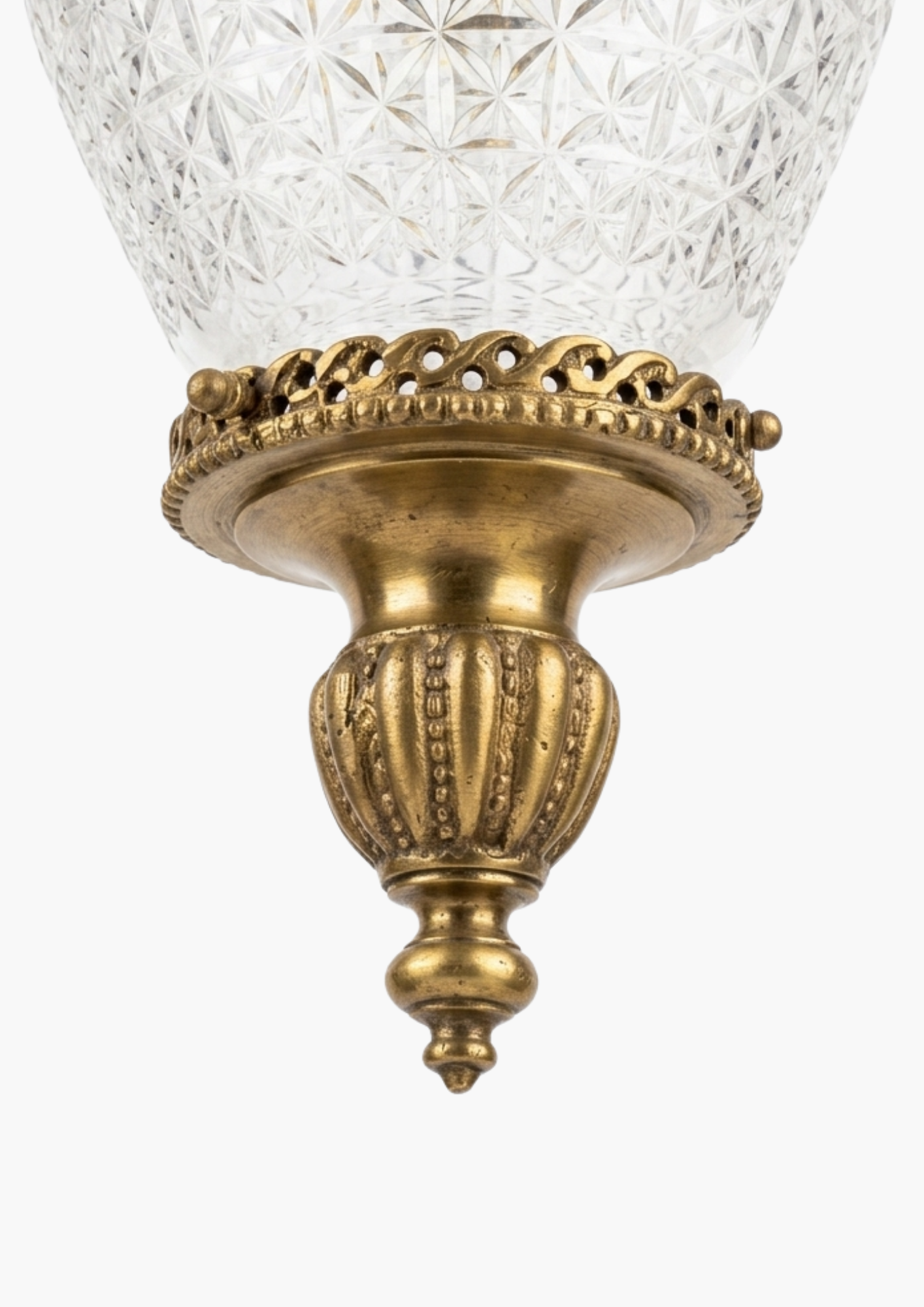 Decorative wall light fixture with glass shade and gold metal base on a white background