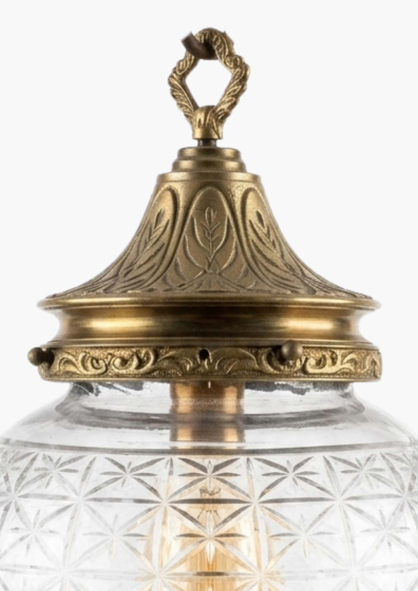 Decorative outdoor light fixture with brass top and clear glass shade on a white background