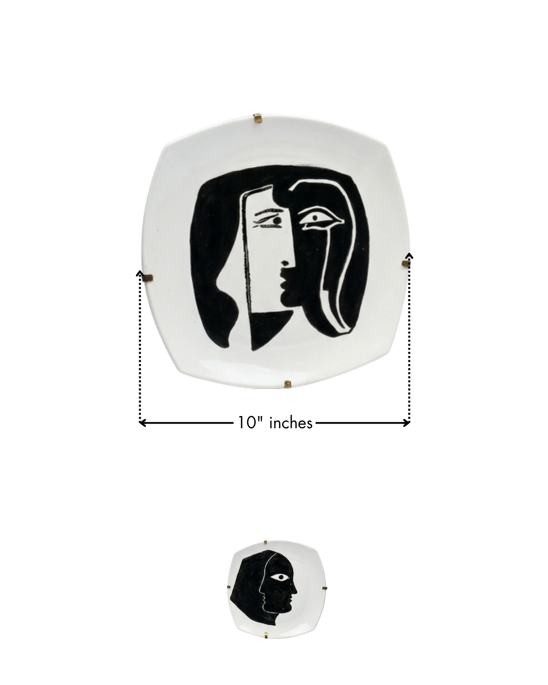 Decorative wall art with a black and white face design on a white background, showing measurements.