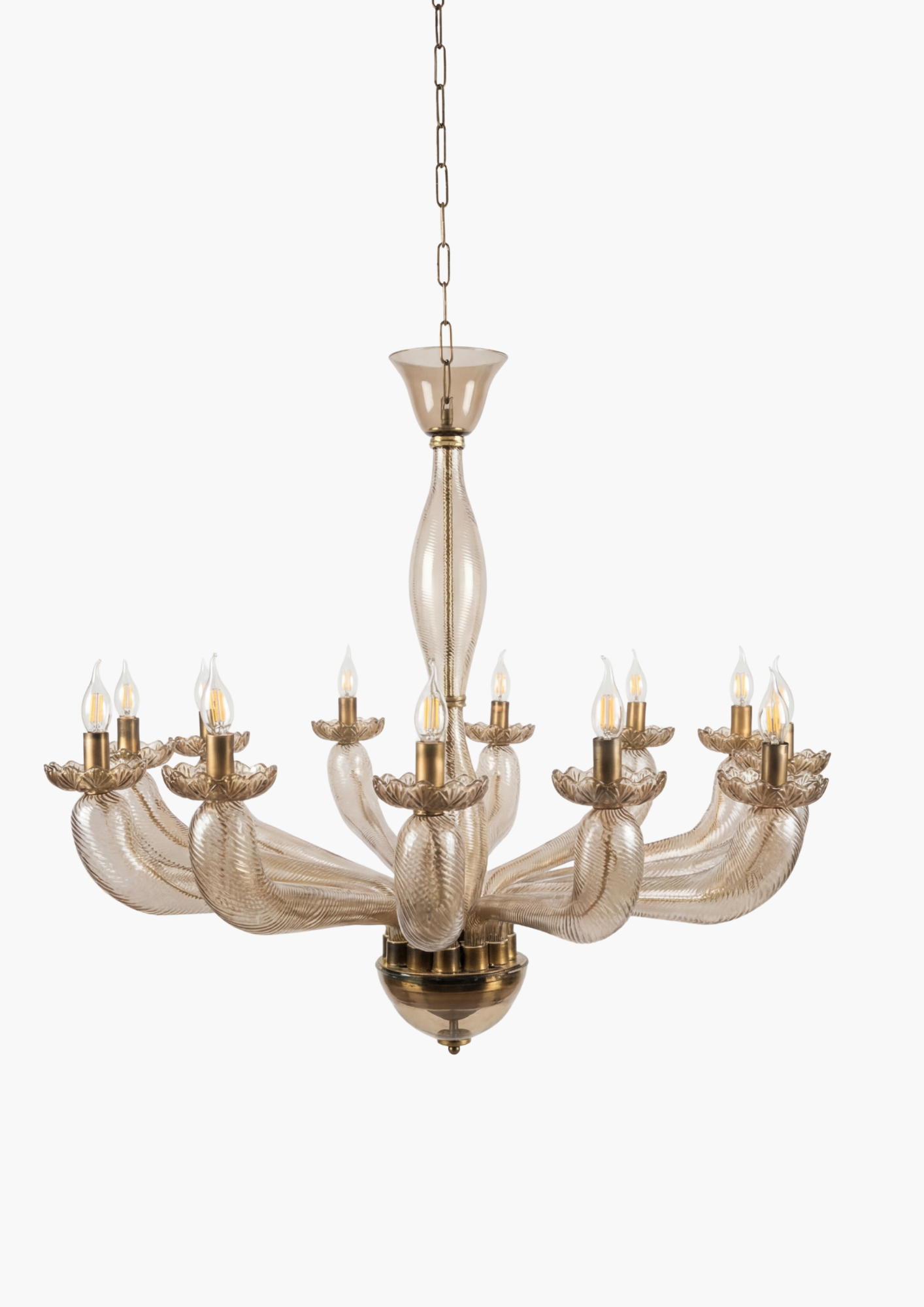 Decorative chandelier with glass arms and brass accents on a white background